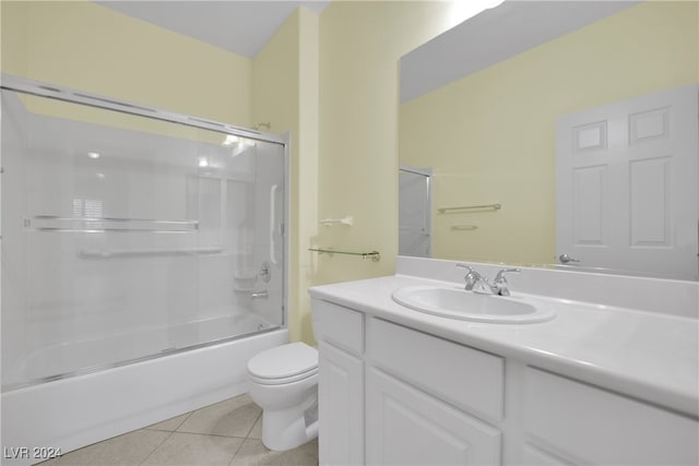 full bathroom with tile patterned flooring, vanity, combined bath / shower with glass door, and toilet