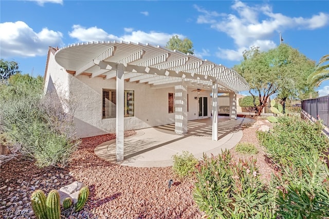 back of house with a pergola, ceiling fan, and a patio