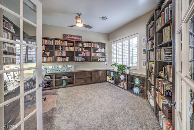 carpeted home office with ceiling fan