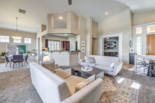 living room with plenty of natural light and high vaulted ceiling