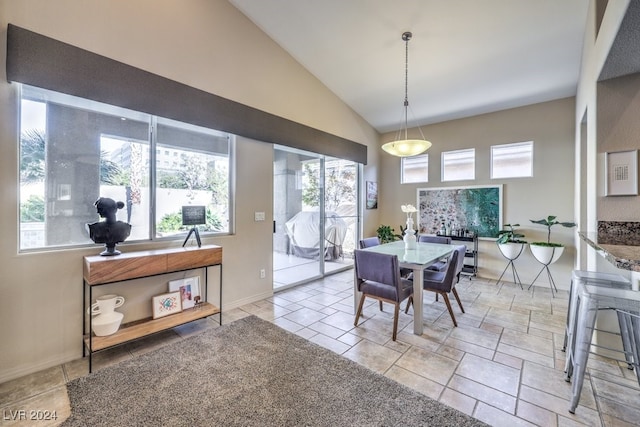 dining room with high vaulted ceiling