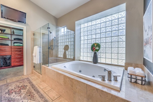 bathroom featuring shower with separate bathtub