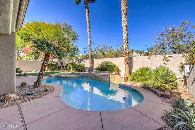 view of swimming pool with an in ground hot tub