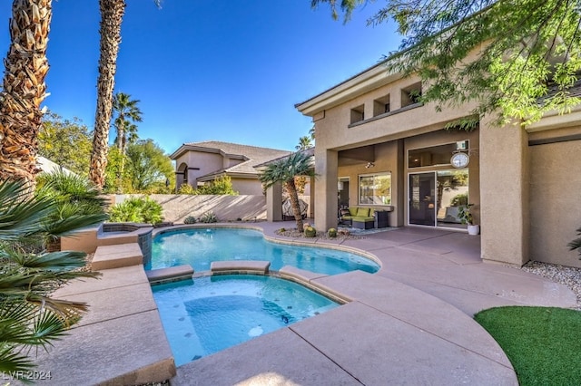 view of swimming pool with an in ground hot tub and a patio area