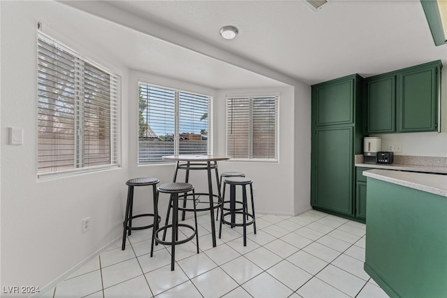 kitchen featuring green cabinets and light tile patterned floors