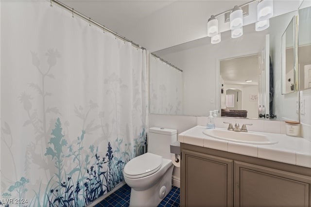 bathroom with vanity, curtained shower, and toilet