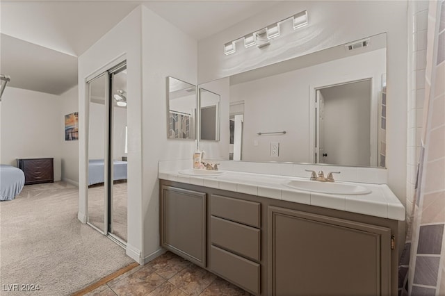 bathroom with tile patterned floors and vanity