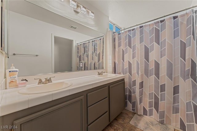 bathroom featuring tile patterned floors and vanity