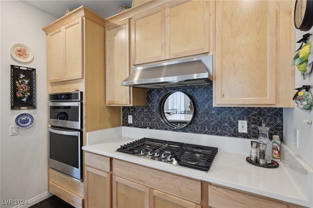 kitchen with light brown cabinets, backsplash, and stainless steel appliances