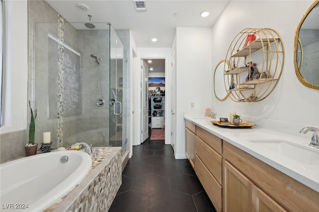 bathroom with tile patterned floors, vanity, and separate shower and tub