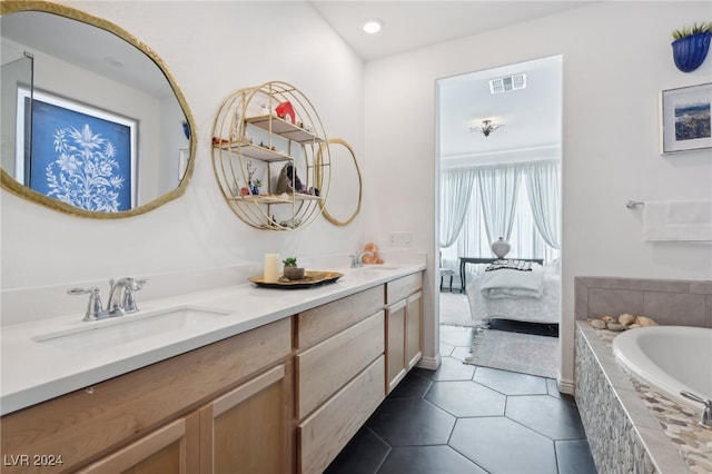 bathroom featuring tile patterned floors, vanity, and a relaxing tiled tub