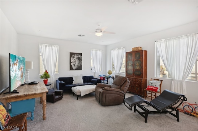 sitting room featuring ceiling fan and light carpet