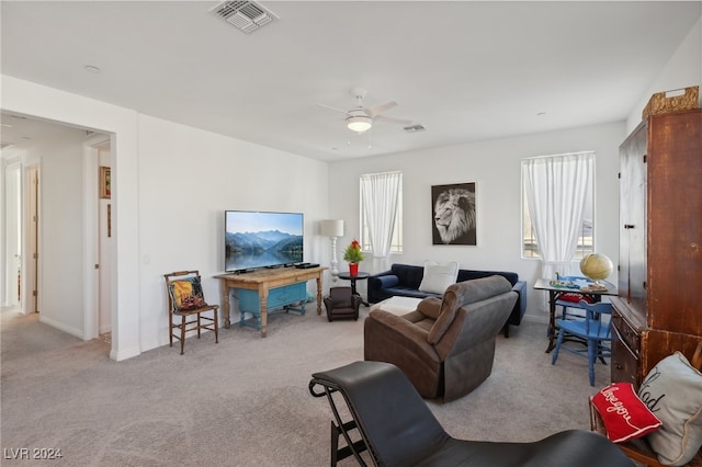 living room featuring light carpet and ceiling fan