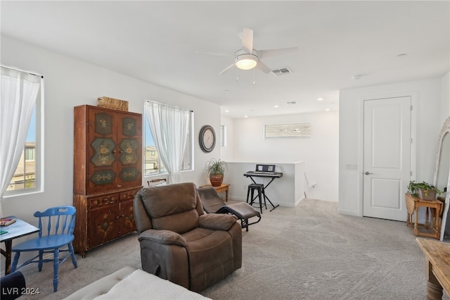 living room featuring ceiling fan and light colored carpet