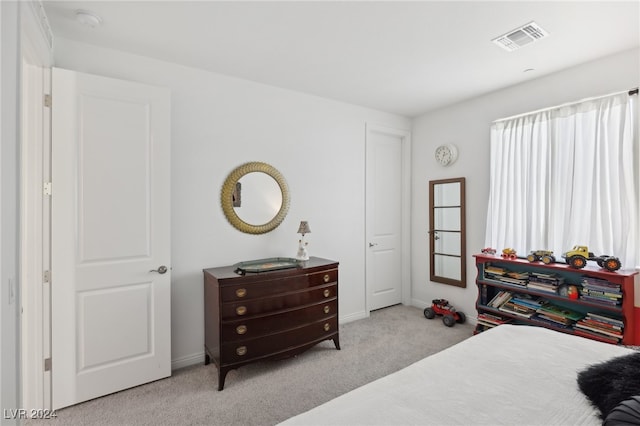 bedroom featuring light carpet