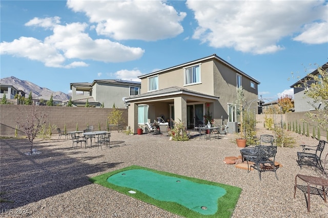 back of house with a patio