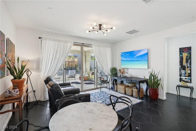 living room featuring a notable chandelier and dark tile patterned floors