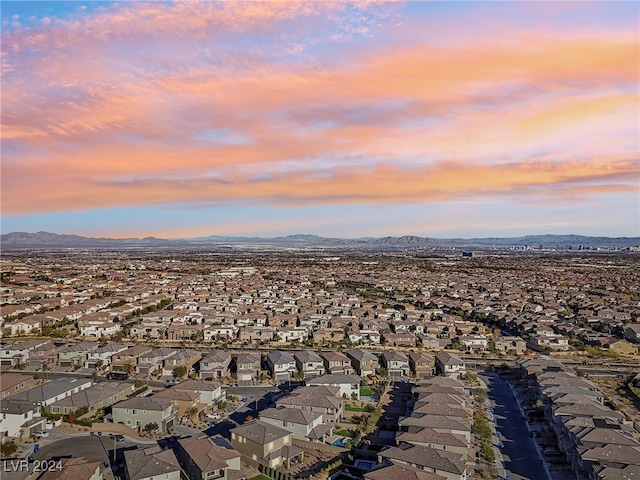 aerial view at dusk featuring a mountain view