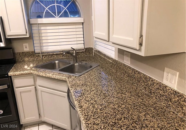 kitchen featuring white cabinets, black range, dishwasher, and sink