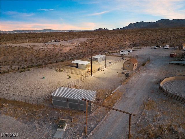 drone / aerial view with view of desert, a rural view, and a mountain view