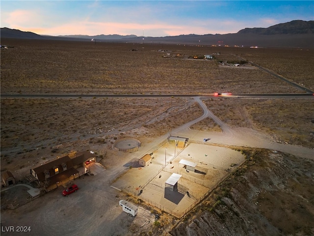 birds eye view of property featuring a mountain view and view of desert