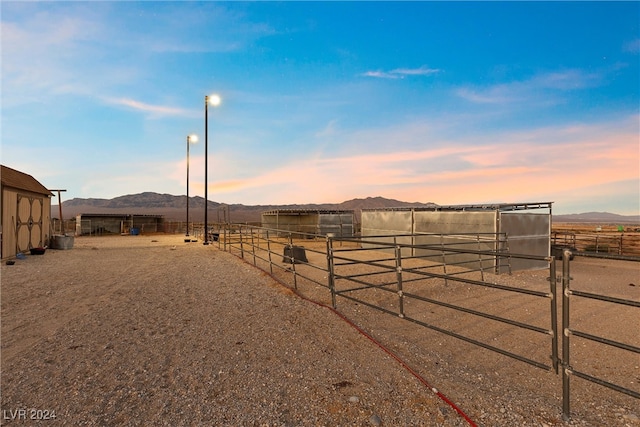 view of yard featuring an outdoor structure, a mountain view, and an exterior structure