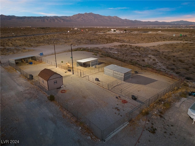 birds eye view of property featuring a desert view, a mountain view, and a rural view