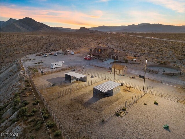 aerial view at dusk featuring a mountain view