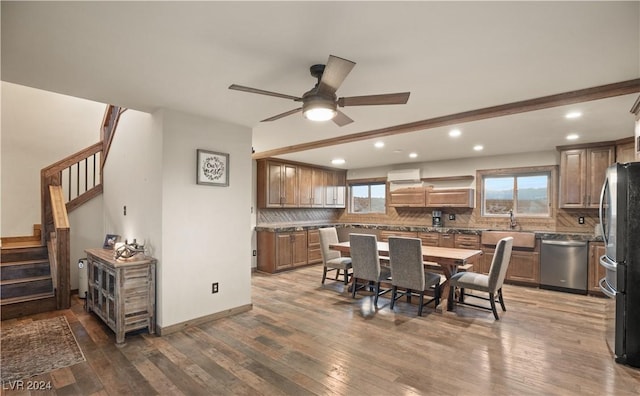 dining room with hardwood / wood-style floors, a ceiling fan, baseboards, recessed lighting, and stairs