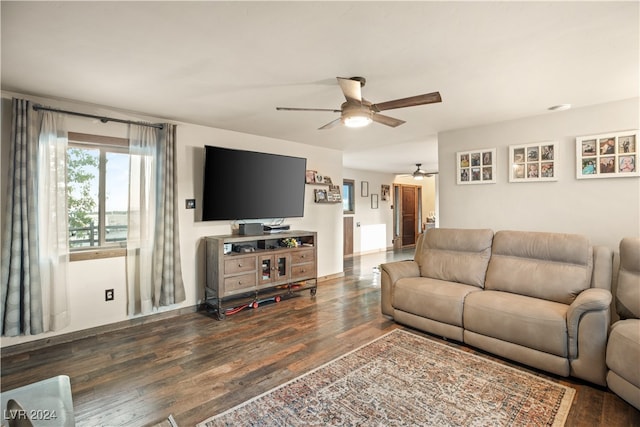 living area with a ceiling fan and wood finished floors