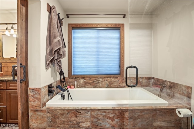 bathroom featuring a bath and vanity