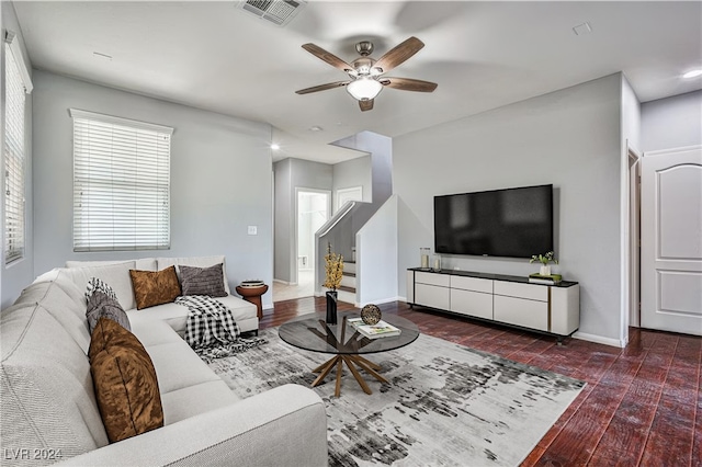 living room with dark hardwood / wood-style floors and ceiling fan