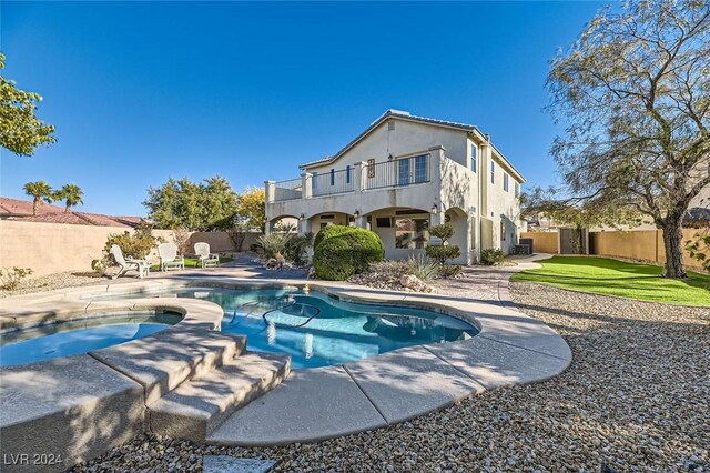 view of swimming pool with a patio area and an in ground hot tub