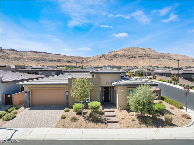 view of front of property featuring a mountain view and a garage