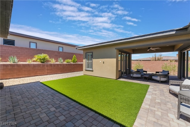 back of property with a patio area, ceiling fan, and an outdoor hangout area