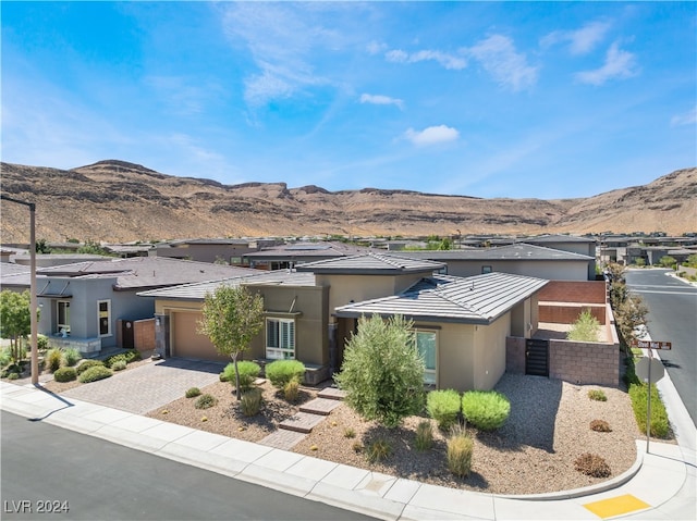 view of front of house with a mountain view and a garage