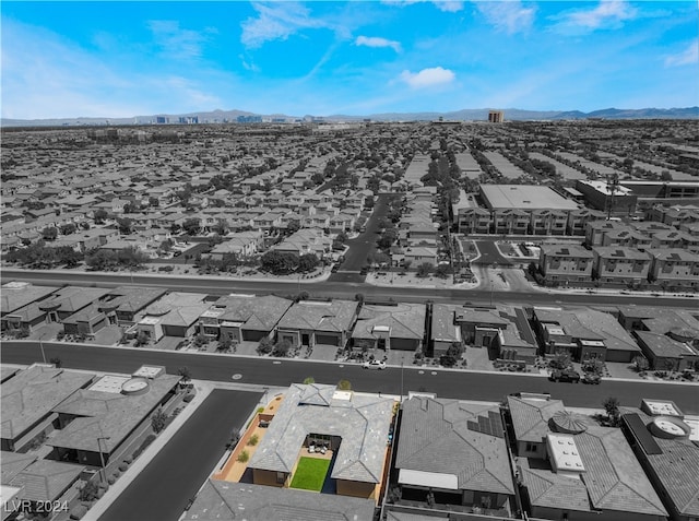 birds eye view of property with a mountain view