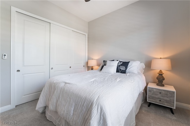 bedroom with light colored carpet and a closet