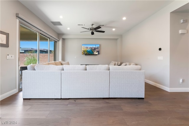 living room featuring ceiling fan and hardwood / wood-style floors