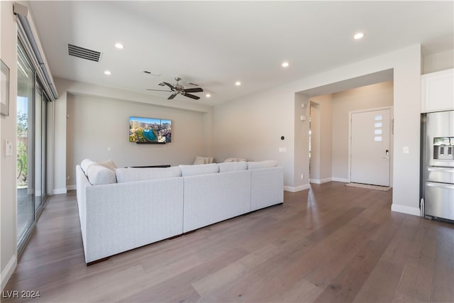 living room with hardwood / wood-style floors and ceiling fan