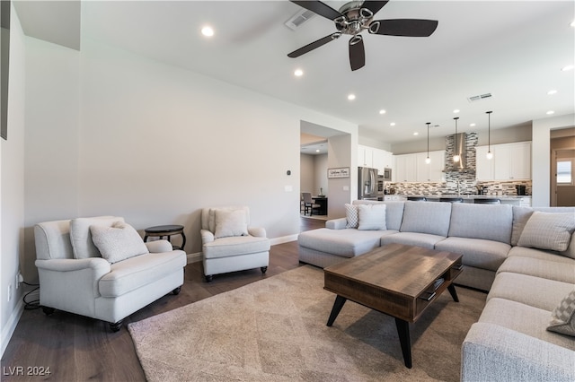 living room with ceiling fan and dark hardwood / wood-style flooring