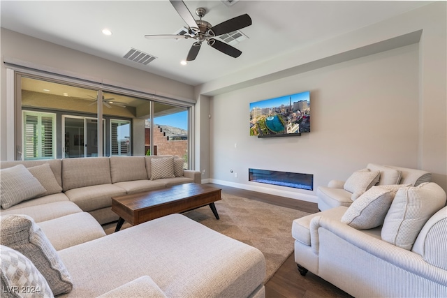 living room featuring hardwood / wood-style floors and ceiling fan