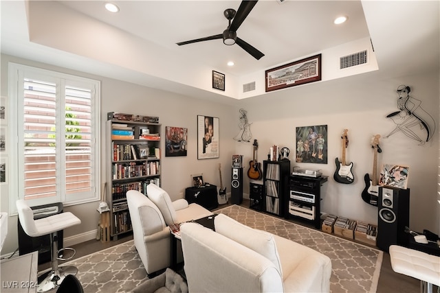 living room with dark hardwood / wood-style flooring and ceiling fan