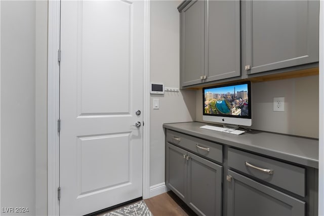 laundry area featuring dark wood-type flooring