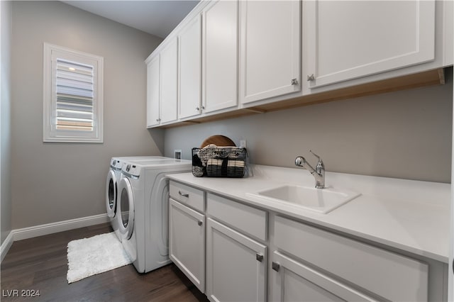 washroom featuring dark hardwood / wood-style floors, cabinets, independent washer and dryer, and sink