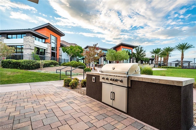 view of patio / terrace with area for grilling, a balcony, and exterior kitchen