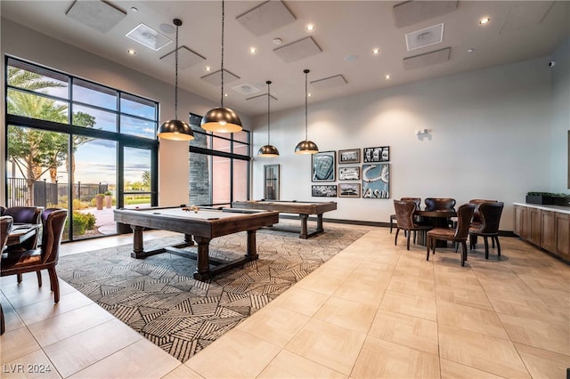 rec room featuring a towering ceiling, light tile patterned floors, and billiards