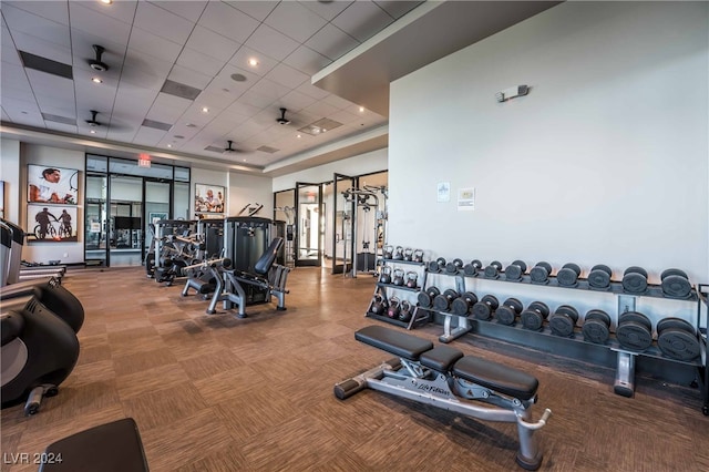 workout area with carpet and a drop ceiling