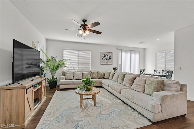 living room featuring dark hardwood / wood-style floors and ceiling fan