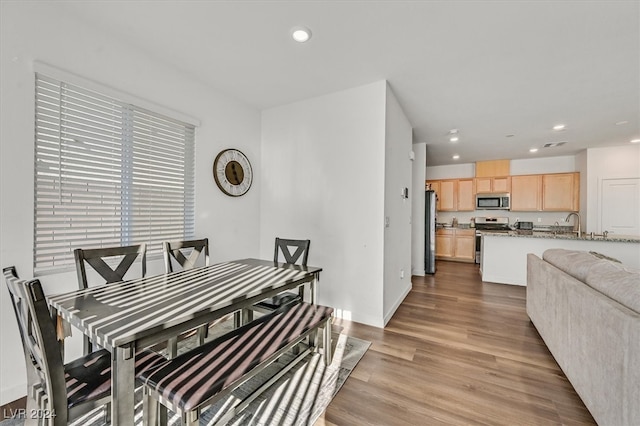 dining area with light hardwood / wood-style flooring